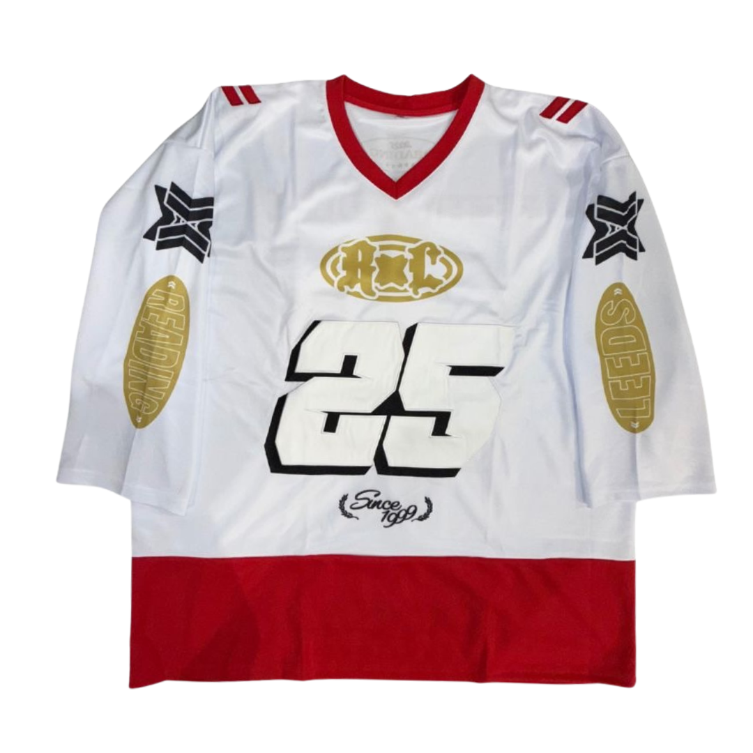 The Oversized Hockey Racer Jersey by 2025 is a white jersey with red shoulders and hem, bold black number 25 on the front, gold Reedooks on the sleeves, black and gold logos, and “Since 1999” scripted at the bottom.