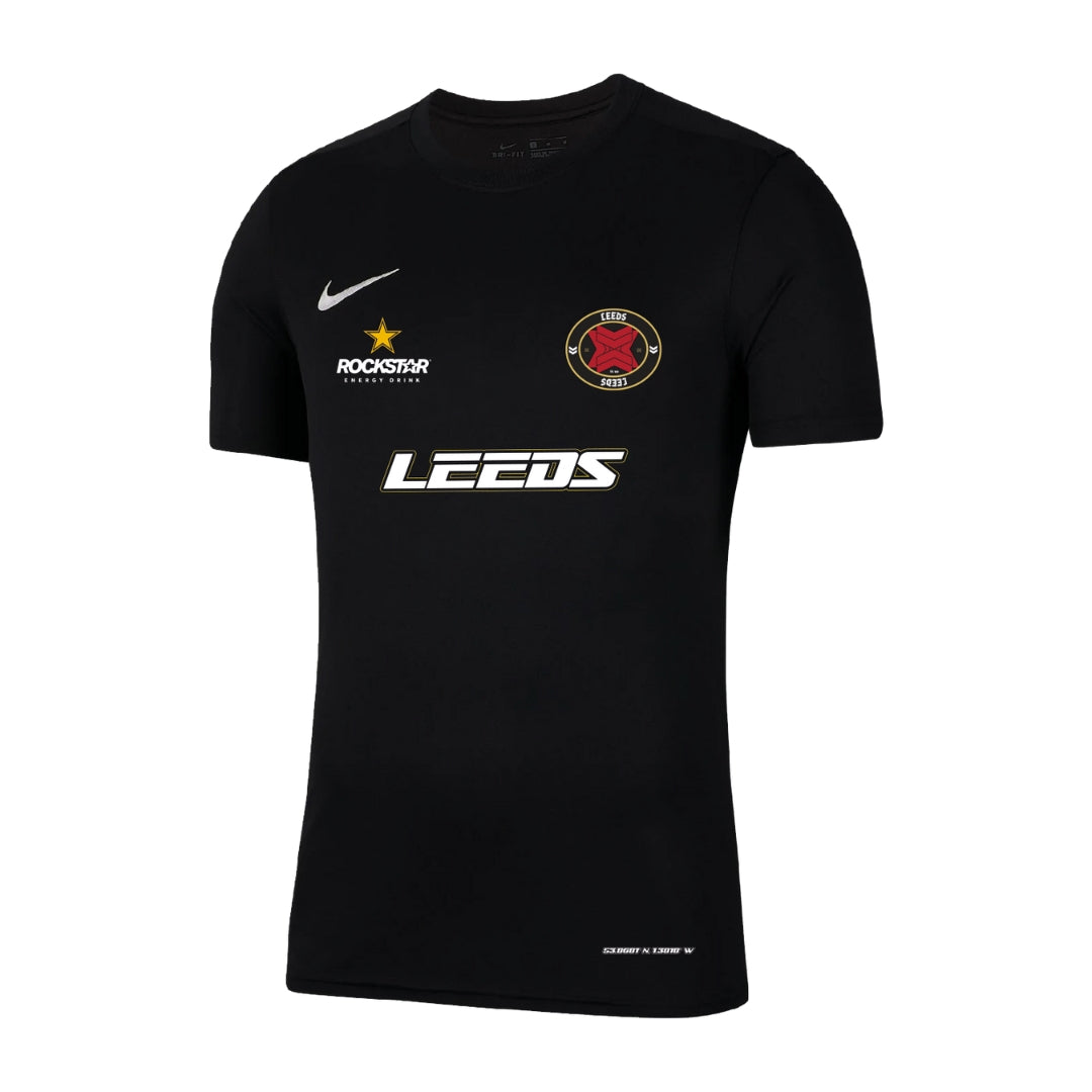 Black short-sleeve Leeds Football Jersey by Reading & Leeds Festival, with white LEEDS text, white Nike logo, gold-star Rockstar logo, and red/black crest featuring crossed knives on the chest.
