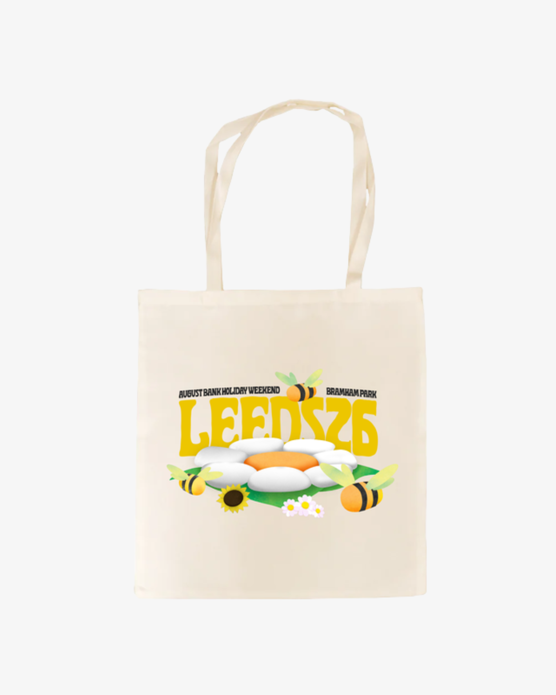The Click & Collect Leeds Tote Bag by R&L Click & Collect 2026 is a cream tote adorned with the word LEEDS in bold yellow letters, surrounded by bees, daisies, eggs, and sunflowers. The text “August Bank Holiday Weekend” and “Bramham Park” appears above.