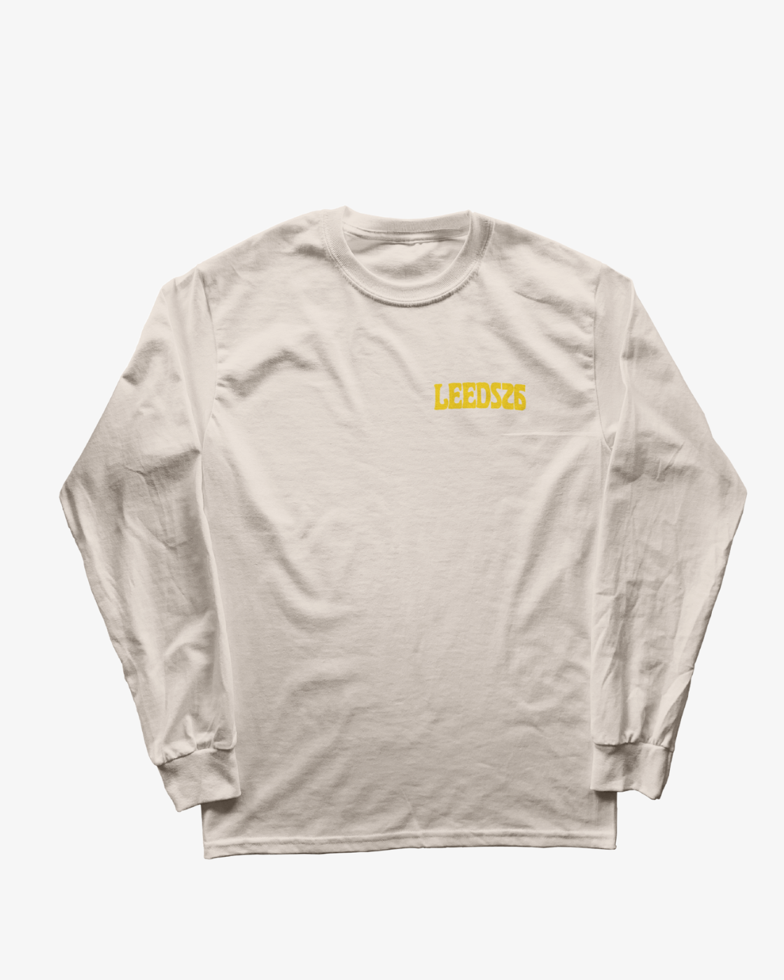 A white long-sleeve shirt from R&L Click & Collect 2026, the Click & Collect 2026 Leeds Line-Up Long Sleeve, featuring “LEEDS26” printed in yellow on the left chest.