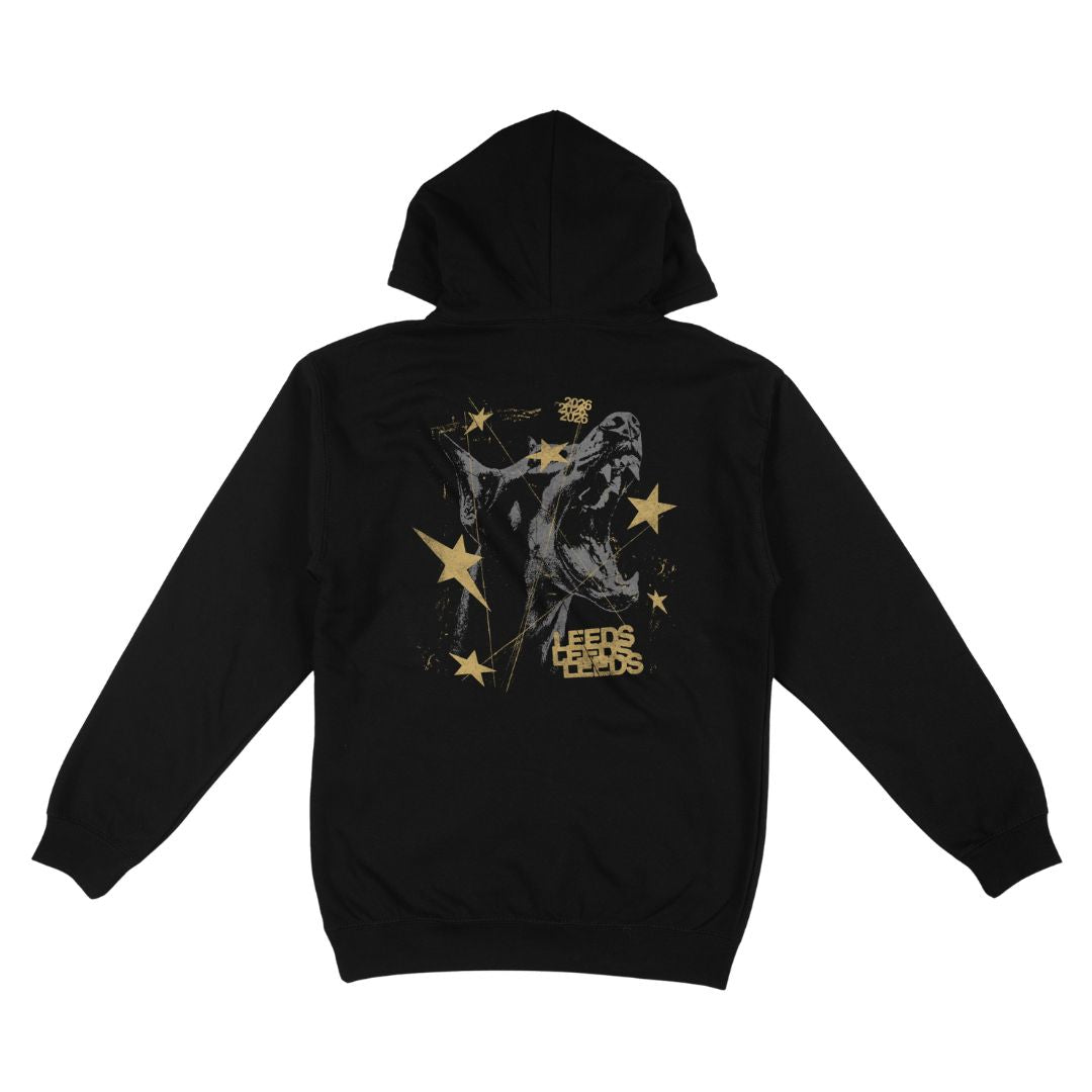 Stay cozy in the Leeds Festival Black Dog Hoodie from Reading & Leeds Festival—a black hoodie featuring a gold and gray graphic of a howling wolf surrounded by gold stars and the text “LEEDS BEADS” on the back. Crafted from ultra-soft Ringspun Cotton for ultimate comfort, this unisex fit hoodie is shown laid flat with sleeves spread and hood up.