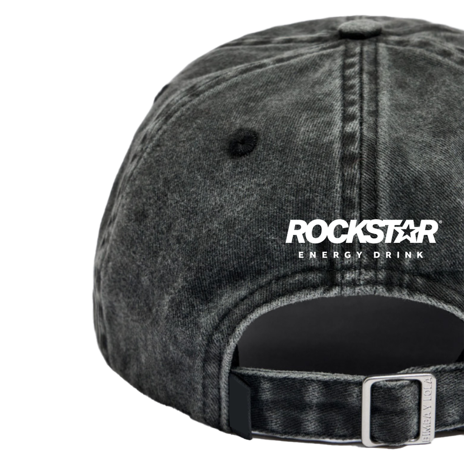 A close-up of the back of a black, washed denim Reading Embroidered Cap by 2025, featuring white text above the adjustable strap and metal clasp.