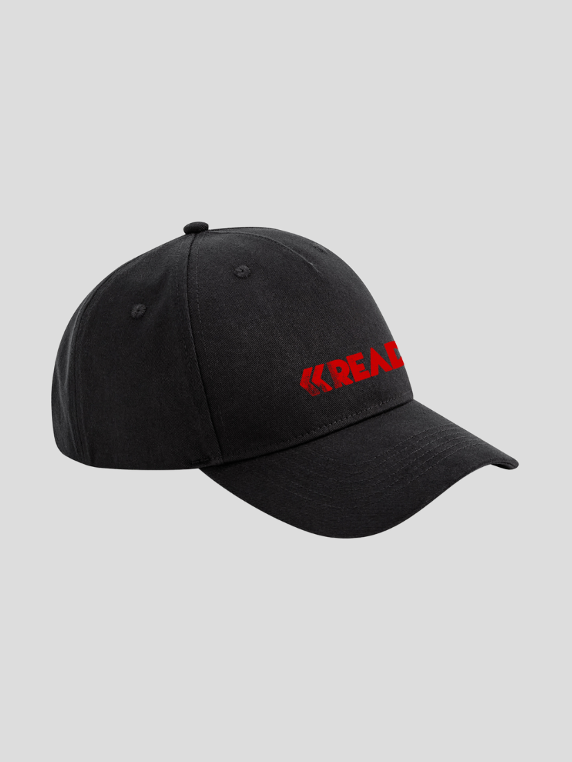 A black Reading 2022 Cap by Reading & Leeds Festival, featuring a curved brim and bold red REACH lettering on the front left panel, displayed against a plain gray background.